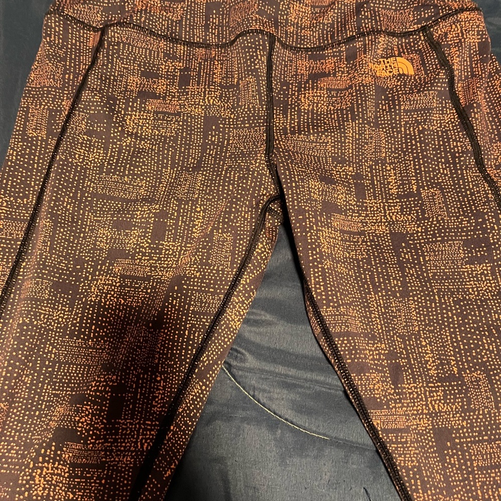 The North Face Orange and Black Patterned Apparel